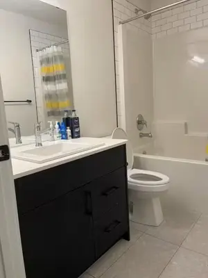 a white bathroom with a sink and a toilet at Bedroom in Upland A in Edmonton