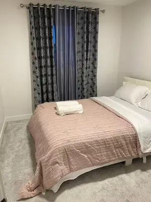 a bedroom with a bed with a blanket on it at Bedroom in Upland B in Edmonton