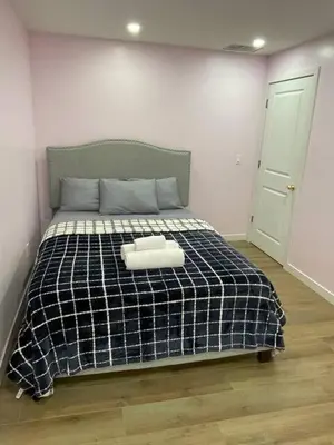 a bedroom with a bed with a black and white blanket at Bedroom in Upland C in Edmonton