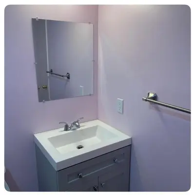 a bathroom with a white sink and a mirror at Bedroom in Upland C in Edmonton