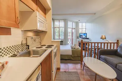 a kitchen with a sink and a living room at Alpenglow Lodge by Elevate Vacations in Whistler