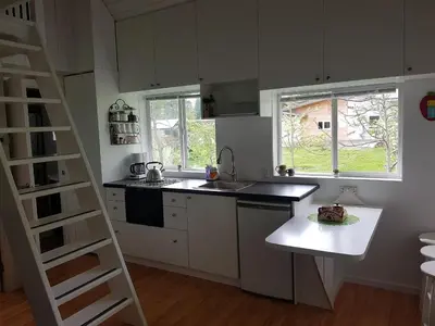 a kitchen with white cabinets and a ladder in it at Cozy Cabin, 2 min to the HWY1 in Tappen