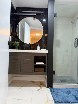 a bathroom with a sink and a mirror at THE GUEST HOUSE WEST EDMONTON Mall in Edmonton