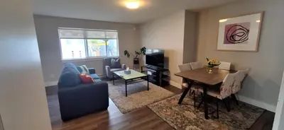 a living room with a table and a dining room at Happy Zone Suite - Sleeps 4, Free Treats ! in Langford