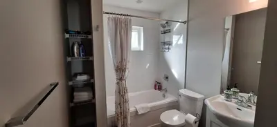 a bathroom with a tub and a sink and a toilet at Happy Zone Suite - Sleeps 4, Free Treats ! in Langford
