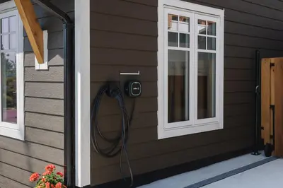 a shower on the side of a house at Brass Apple Cottage in Campbell River