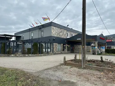 a building with flags on top of it at Fortunes Landing Motor Inn in Enderby