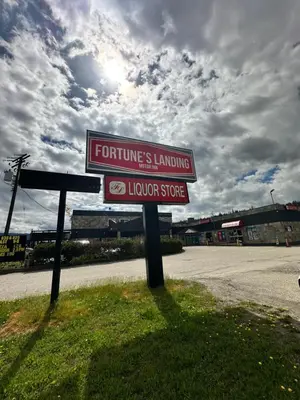 a sign for a store on the side of a road at Fortunes Landing Motor Inn in Enderby