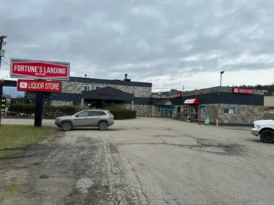 a car parked in a parking lot in front of a building at Fortunes Landing Motor Inn in Enderby