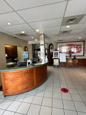 a restaurant with a counter in the middle of a room at Fortunes Landing Motor Inn in Enderby