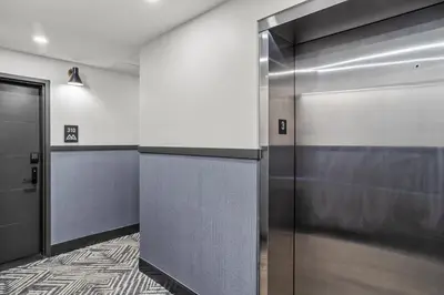 a hallway with two elevators in a building at Golden Escape 2 Bdrm Mountain VIEWS - managed by Little Sister Getaways in Canmore