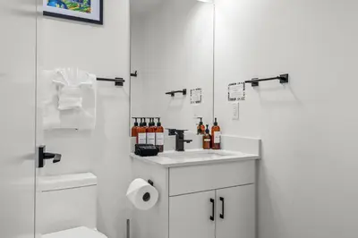 a white bathroom with a sink and a shower at Golden Escape 2 Bdrm Mountain VIEWS - managed by Little Sister Getaways in Canmore