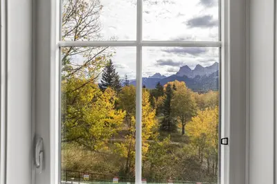 a window with a view of the mountains at Golden Escape 2 Bdrm Mountain VIEWS - managed by Little Sister Getaways in Canmore