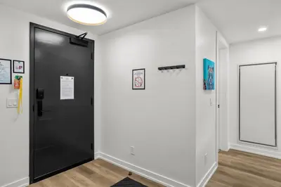a hallway with a black door and a window at Golden Escape 2 Bdrm Mountain VIEWS - managed by Little Sister Getaways in Canmore