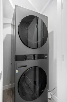 two microwave ovens sitting next to each other at Modern 2BR Private Suite NW Near Airport & Amazing Shopping! Free Banff Pass, Netflix, Parking! in Calgary