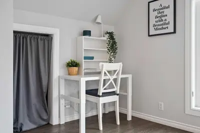 a white desk with a chair in a room at Local Loft - Downtown Okotoks - 2BD - Private in Okotoks