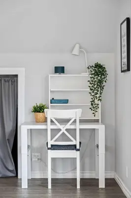 a white desk with a plant on top of it at Local Loft - Downtown Okotoks - 2BD - Private in Okotoks