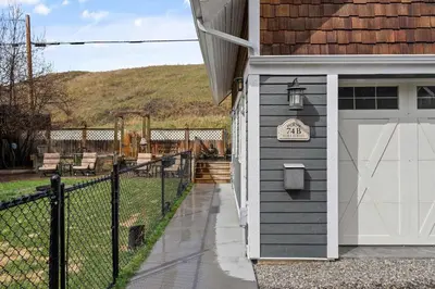 a garage with a sign on the side of a house at Local Loft - Downtown Okotoks - 2BD - Private in Okotoks