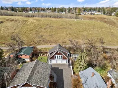 an aerial view of a house with a hill at Local Loft - Downtown Okotoks - 2BD - Private in Okotoks