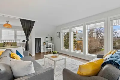 a living room with two couches and a table at Local Loft - Downtown Okotoks - 2BD - Private in Okotoks
