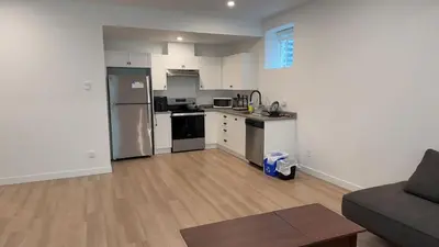 an empty kitchen and living room with a couch at Basement suite -Langley Willoughby in Langley
