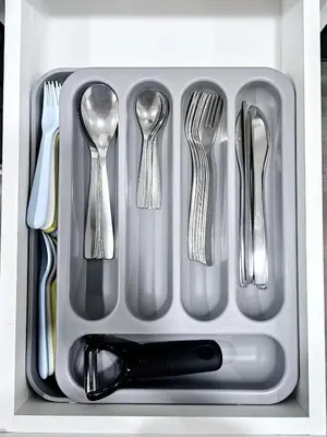 a plastic tray with utensils in a drawer at A Cozy Home away from Home in Edmonton