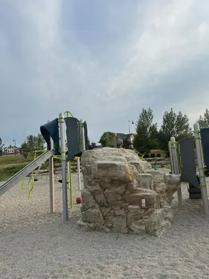 a playground with two slides and a rock at Exquisite Entire 4- Bed rooms vacation home! in Calgary