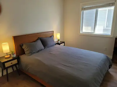 a bedroom with a bed with two lamps and a window at Exquisite Entire 4- Bed rooms vacation home! in Calgary