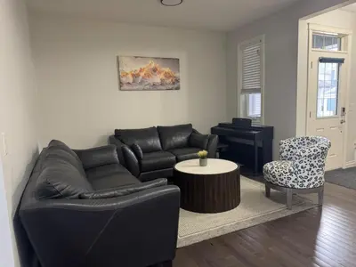 a living room with a couch and a table at Exquisite Entire 4- Bed rooms vacation home! in Calgary
