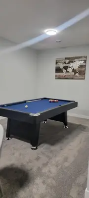 a blue ping pong table in a room at Cozy 1 bedroom basement suite in Southwest Calgary in Calgary