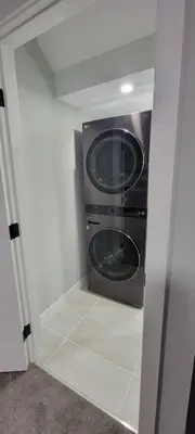 a washer and dryer in a small room at Cozy 1 bedroom basement suite in Southwest Calgary in Calgary