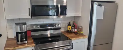 a kitchen with a stainless steel stove and a microwave at Sea view stay in Lantzville