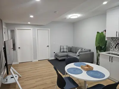 a living room with a table and a couch at Lovely Brand New 2 Bedroom Suite in Calgary in Calgary