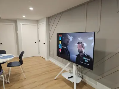 a flat screen tv on a wall in a living room at Lovely Brand New 2 Bedroom Suite in Calgary in Calgary