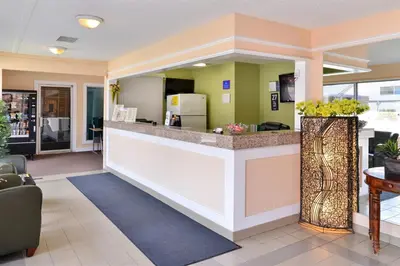 a lobby of a hotel with a reception counter at Canadas Best Value Inn Whitecourt in Whitecourt