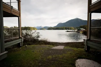 a view of a lake with a boat in the water at Island Vista - Waterfront Condo in Tofino