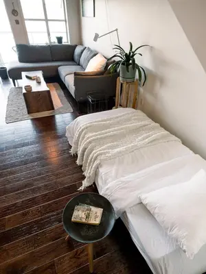 a living room with a couch and a table at Island Vista - Waterfront Condo in Tofino