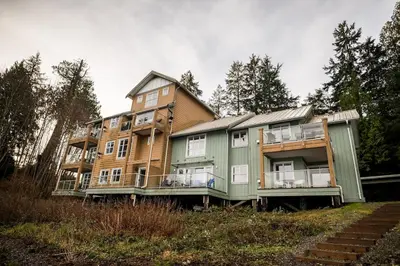 a large apartment building sitting on top of a hill at Island Vista - Waterfront Condo in Tofino