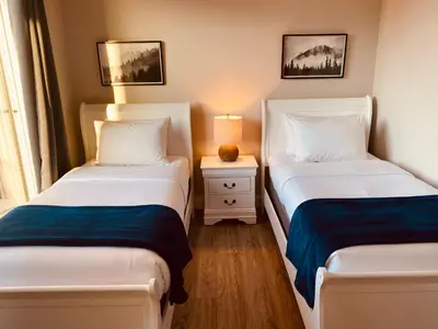 a bedroom with two beds and a lamp on a table at Haven On The Hill in Port Renfrew