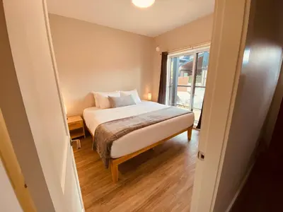 a bedroom with a bed and a window at Haven On The Hill in Port Renfrew