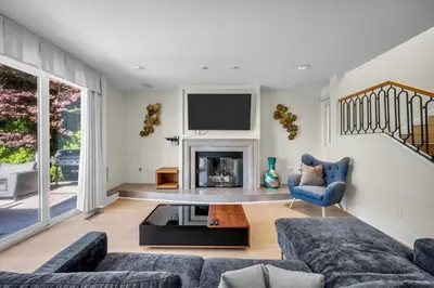 a living room with a couch and a fireplace at Spectacular, Water View House! Property overview! in West Vancouver