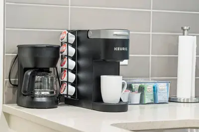 a coffee maker on a counter in a kitchen at Tropical Caribbean-Themed Cozy Getaway - King Bed-Free Parking in Calgary
