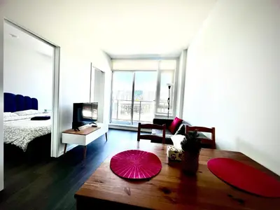 a living room with a bed and a large window at Fashion 1B1B locates in the heart of Richmond in Richmond