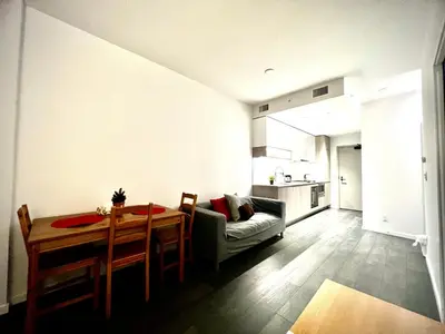 a living room with a dining room table and a kitchen at Fashion 1B1B locates in the heart of Richmond in Richmond