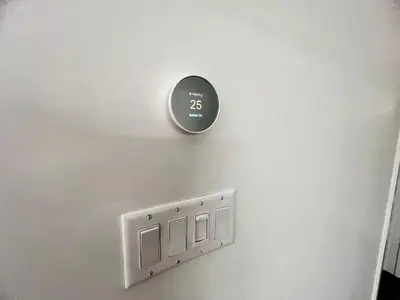 a clock on a wall with a lightswitch at Stylish 1B1B locates in the heart of Richmond in Richmond