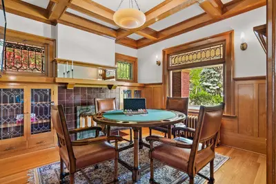 a dining room with a table and chairs and a laptop at Historic Treend Residence in the heart of Mission Calgary in Calgary