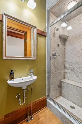 a bathroom with a sink and a shower at Historic Treend Residence in the heart of Mission Calgary in Calgary