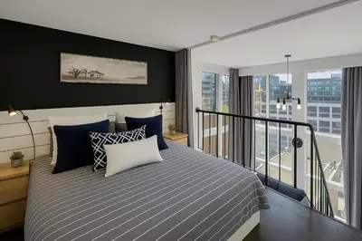 a bedroom with a bed and a balcony at Trendy Downtown Loft Apartment - King Bed! in Vancouver