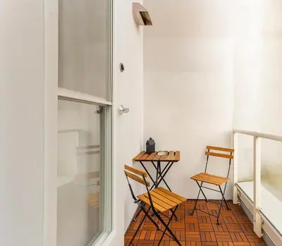 two chairs and a table in a room with a window at Trendy Downtown Loft Apartment - King Bed! in Vancouver