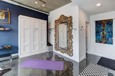 a purple yoga mat on the floor next to a mirror at Boutique Studio City Views, Patio, Fireplace Voglio Bene in Calgary